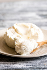Fresh homemade mascarpone. Traditional Mascarpone cheese in wooden spoon