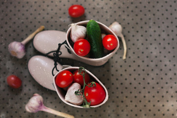 Autumn. The harvest of garlic. Rubber boots on brown background. Top view. Flat lay