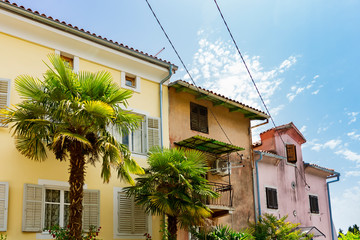 colorful houses with palm trees in Lovran, Croatia