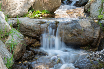 water fall through the stone in blue tint