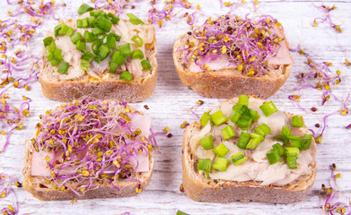 Sandwiches with ham, smoked mackerel and kale sprouts as an ingredient of a healthy diet.