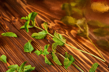 mint - ingredients for making lemonade on brown wooden table. close up side view