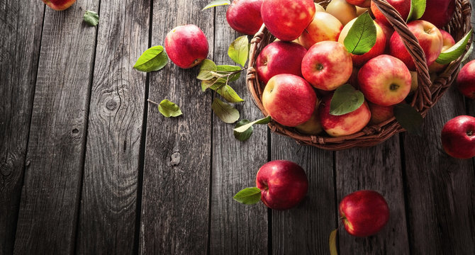 Fresh Red Apples With Green Leaves On A Wooden  Background