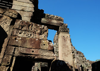 The ruins of medieval Khmer buildings. Fragments of decorative stone carving.