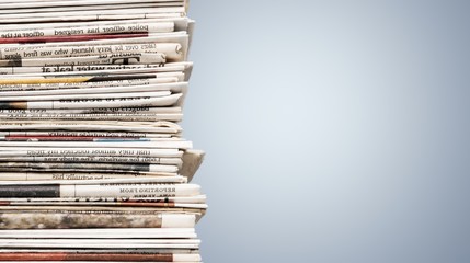 Pile of newspapers on white background