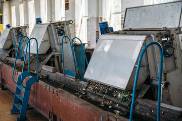 Wastewater treatment plant. Conveyor belt machinery for sewage filtration and separation from hard impurities objects