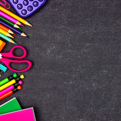 School supplies side border. Overhead view on a chalkboard background with copy space. Back to...
