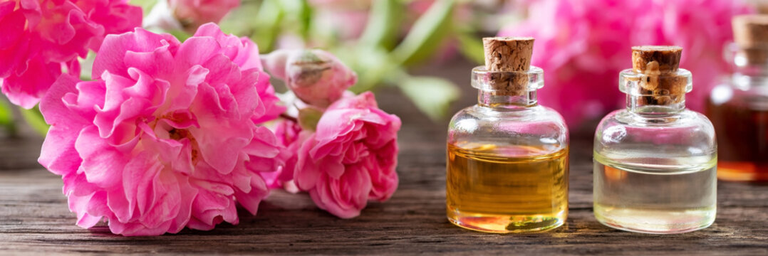 Panoramic header of essential oil bottles and roses