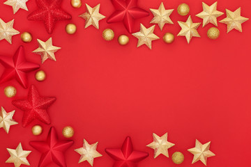Christmas red star and gold bauble background border with copy space. Traditional greetings card for the festive season.