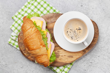 Coffee and croissant sandwich