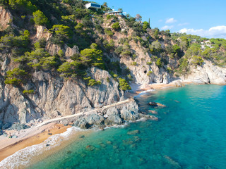 Fototapeta premium Aerial view of beautiful coastline in Mediterranean coast of Spain, Costa Brava. Panorama of Rocks on the coast in beautiful summer day. Beautiful beach with turquoise sea, holiday destination