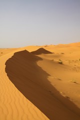 Fototapeta na wymiar Lonely isolated sand dunes belt in the Sahara desert near Erg Chebbi, Morocco