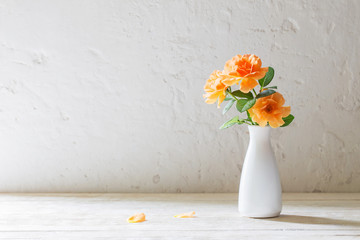 roses in vase on background white wall