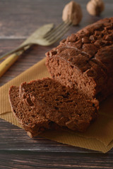 Piece of chocolate cake , fudge or pound cake. Wooden background.