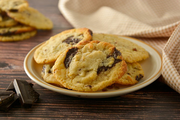 Homemade chocolate cookies on wooden table.