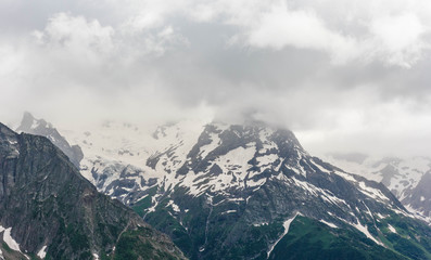 Dombay mountain range in the Caucasus in summer, snow-capped peaks and green mountain slopes