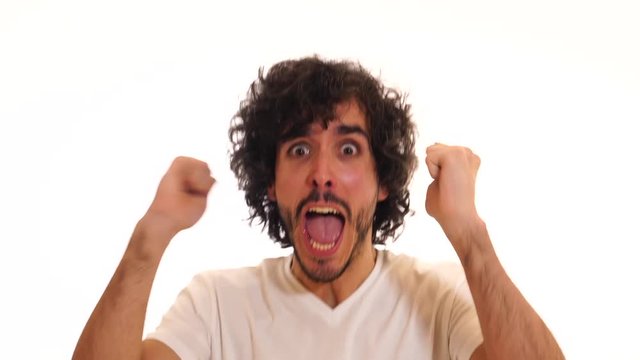 Very excited happy and shocked man winning the lottery, having great success or hearing great news with surprised face and celebration gestures. Human emotions and expressions. Studio shot.