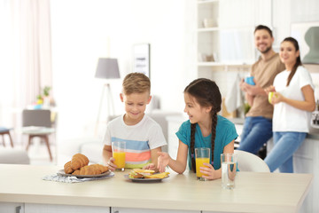 Happy family having breakfast together in kitchen