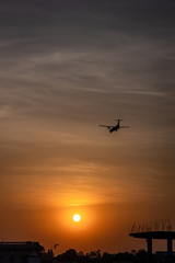 Airplane taking off or landing during sunset