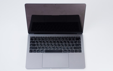 Gray notebook computers are placed in isolated white backgrounds.
