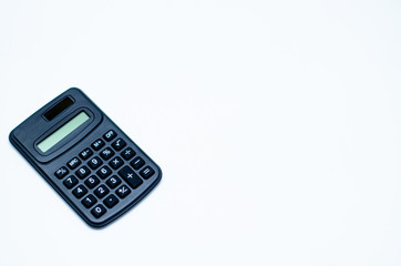 Black calculator placed isolated on a white background.Copy space.