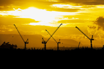 Fototapeta na wymiar silhouette of construction site crane with sky