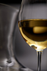 A glass full of wine and wine decanters