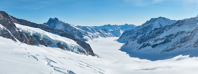Winter mountains panorama with Aletsch glacier covered by the snow. View from Jungfraujoch in Bernese oberland in Switzerland.