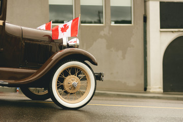 A Vintage Vehicle Flying Two National Flags of Canada
