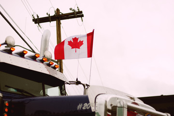 The Canadian National Flag Flying on a Semi-Truck 