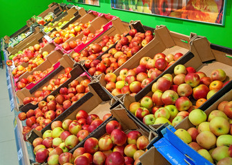 Counter with apples for sale in the supermarket store. Fruits and vegetables