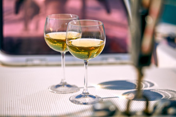 Pair of wineglasses against the yacht