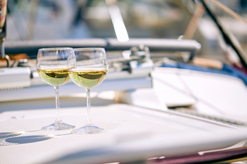 Pair of wineglasses against the yacht