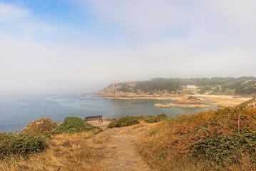 Portelet Bay from the cliffside at Noirmont Point in Jersey.  A mist begins to envelope the opposite headland.