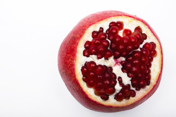 Juicy ripe pomegranate on white background. Pomegranate seeds