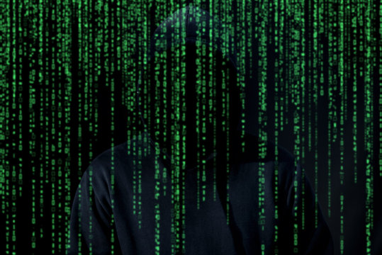 Asian hacker in black hood on black background,Hack password,hacking safety systems to steal information