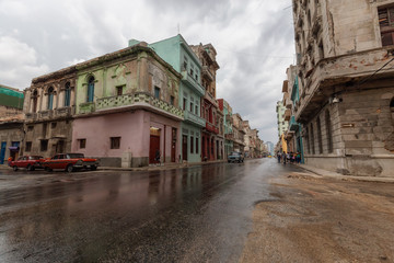 Naklejka na ściany i meble Street view of the beautiful Old Havana City, Capital of Cuba, during a wet and rainy day.