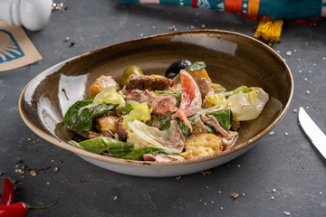 Caesar Salad Bacon is placed in a dish on a table.