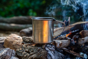 steel cup on an open fire in nature.