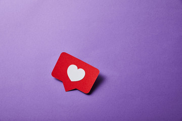 card with like sign on purple surface