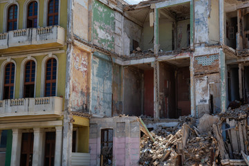 View of the broken and demolished residential homes in the Old Havana City, Capital of Cuba, during a cloudy and sunny day.