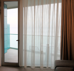 Living room with glass door to balcony. Sea view.