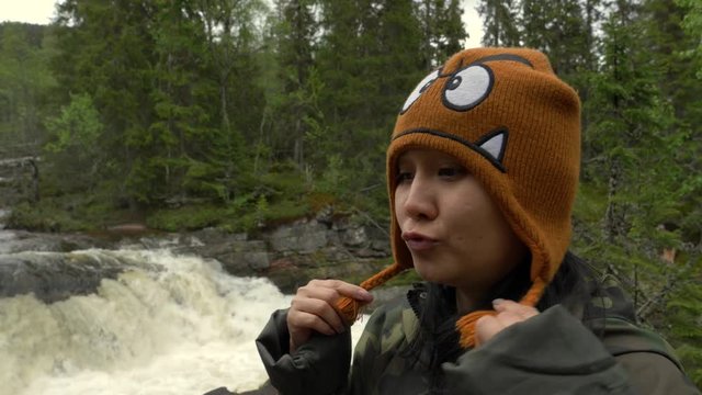 Woman doing funny faces in a forest in Norway.