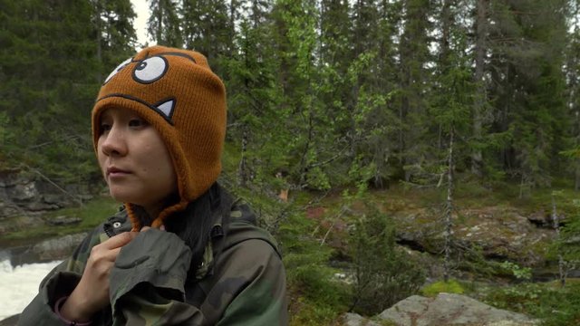 Sad woman on a cold day in a forest in slow motion