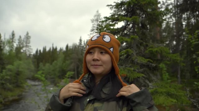 Woman doing funny things in a cold forest of Norway.