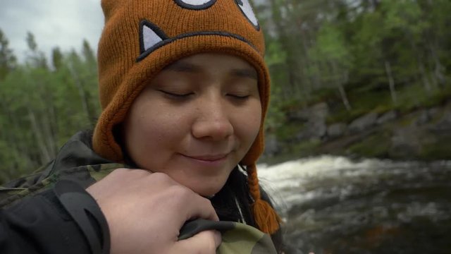 Hand over the shoulder of a girl in a forest of Norway.