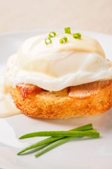 Breakfast is Eggs Benedict - toasted English muffins, bacon, ham, poached eggs, herbs and delicious buttery hollandaise sauce.