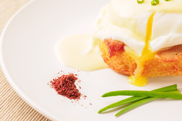 Breakfast is Eggs Benedict - toasted English muffins, bacon, ham, poached eggs, herbs and delicious buttery hollandaise sauce.