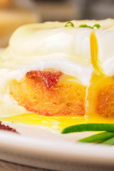 Breakfast is Eggs Benedict - toasted English muffins, bacon, ham, poached eggs, herbs and delicious buttery hollandaise sauce.