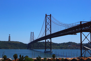 Suspension Bridge over the Tagus or Tejo river with Cristo Rei Sanctuary. Connects the cities of Lisbon and Almada. 25 de Abril Bridge, Lisbon, Portugal.